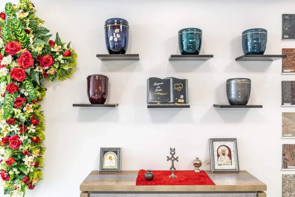 Exposition d'urnes cinéraires, de plaques funéraires et d'objets religieux dans le magasin